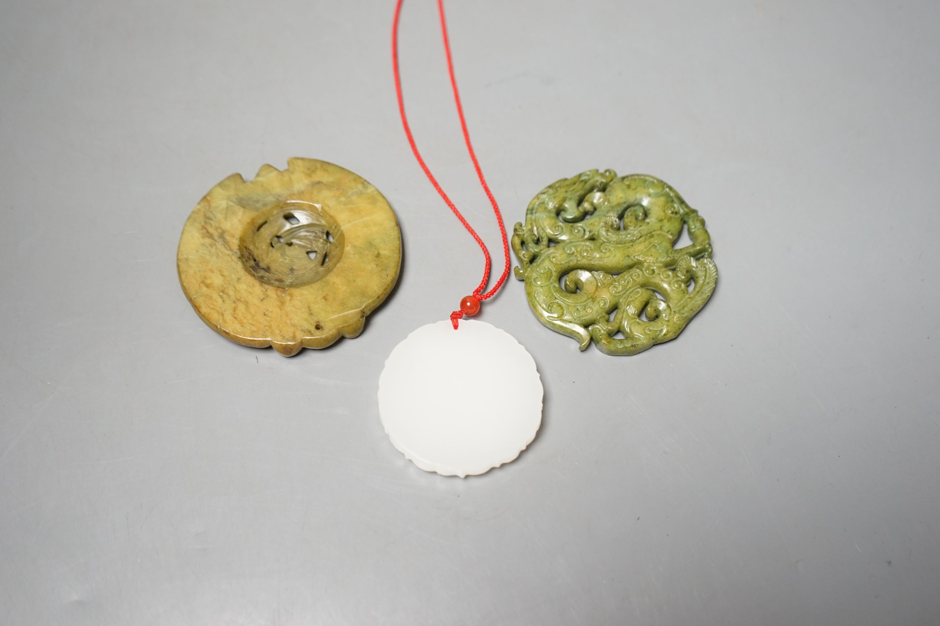 Three Chinese carved jade or hardstone pendants